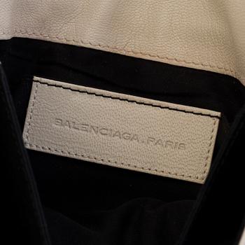 A black and white leather clutch by Balenciaga.