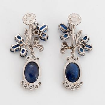 A pair of CF Carlman platinum earrings set with cabochon-cut and faceted sapphires.