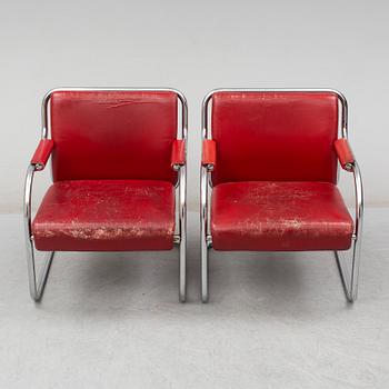 A pair of 1920s armchairs.