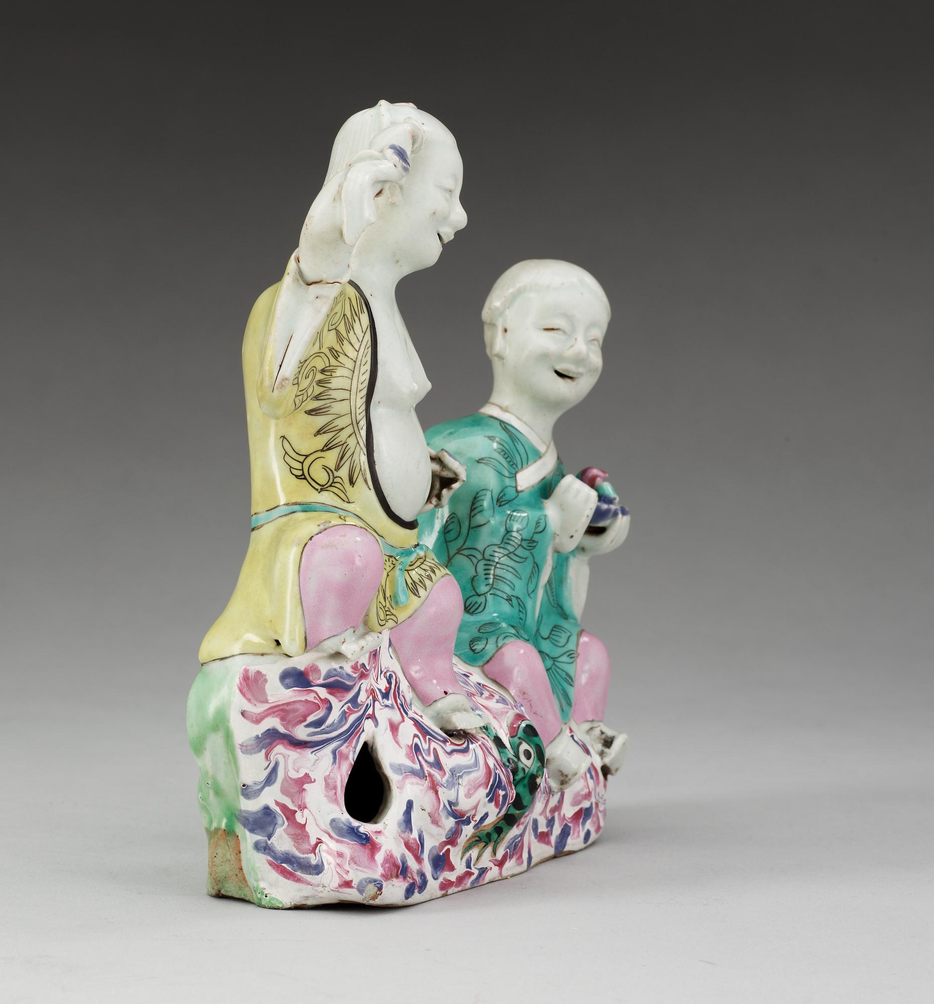A famille rose figure of two boys, Qing dynasty, ca 1800.