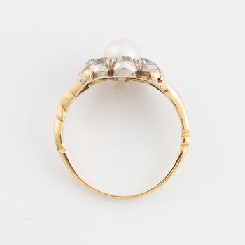 An 18K gold ring and silver set with a pearl and old-cut diamonds.