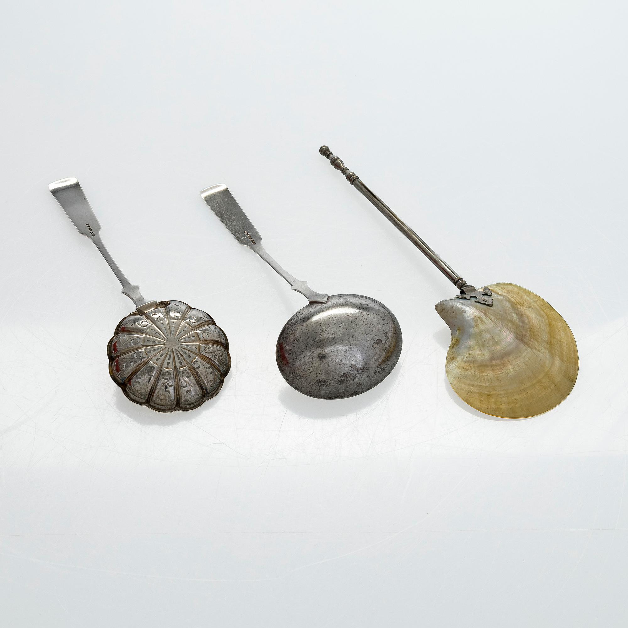 A pair of Russian silver salt cellars, a sprinkle spoon, a sauce ladle, and a tea strainer, Finnish marks.