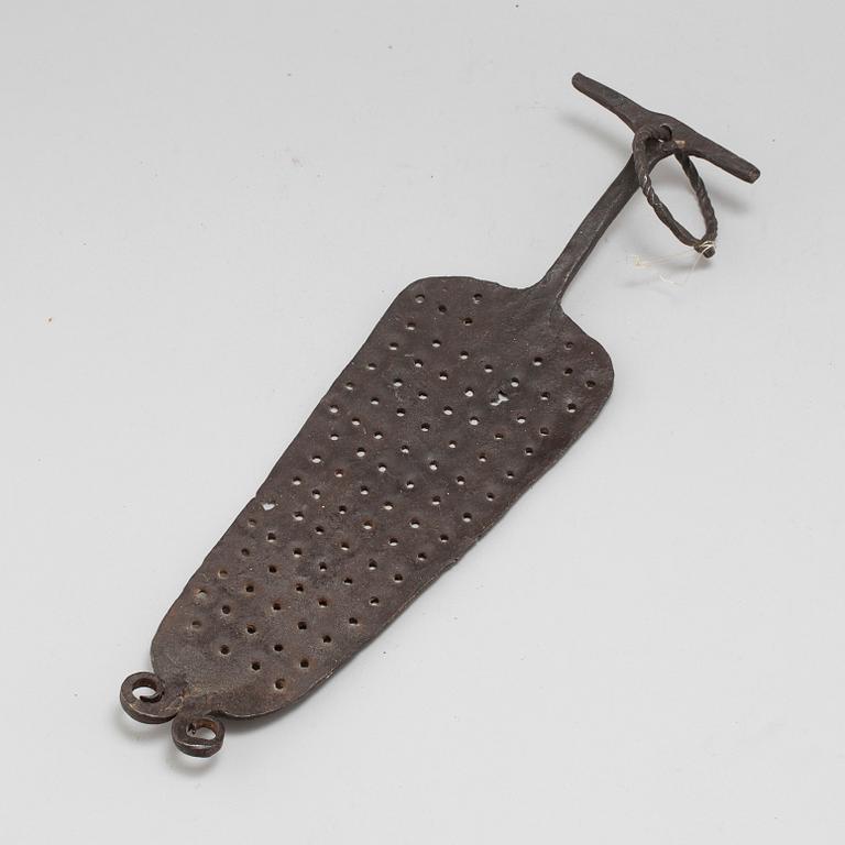 A 18th century iron kitchen tool.
