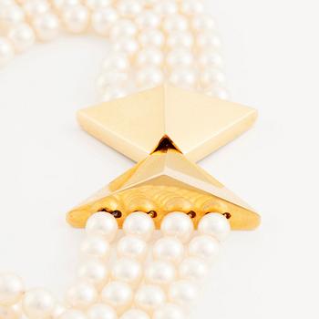Kristian Nilsson, a four strand cultured pearl necklace with an 18K gold clasp, , Stockholm 1985.