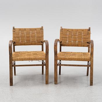 A pair of stained beech armchairs, first half of the 20th Century.