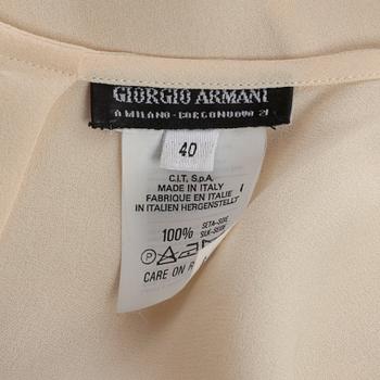 GIORGIO ARMANI, a light beige silk blouse.