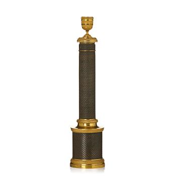 301. A French Empire gilt and patianted bronze travel-candlestick, early 19th century.