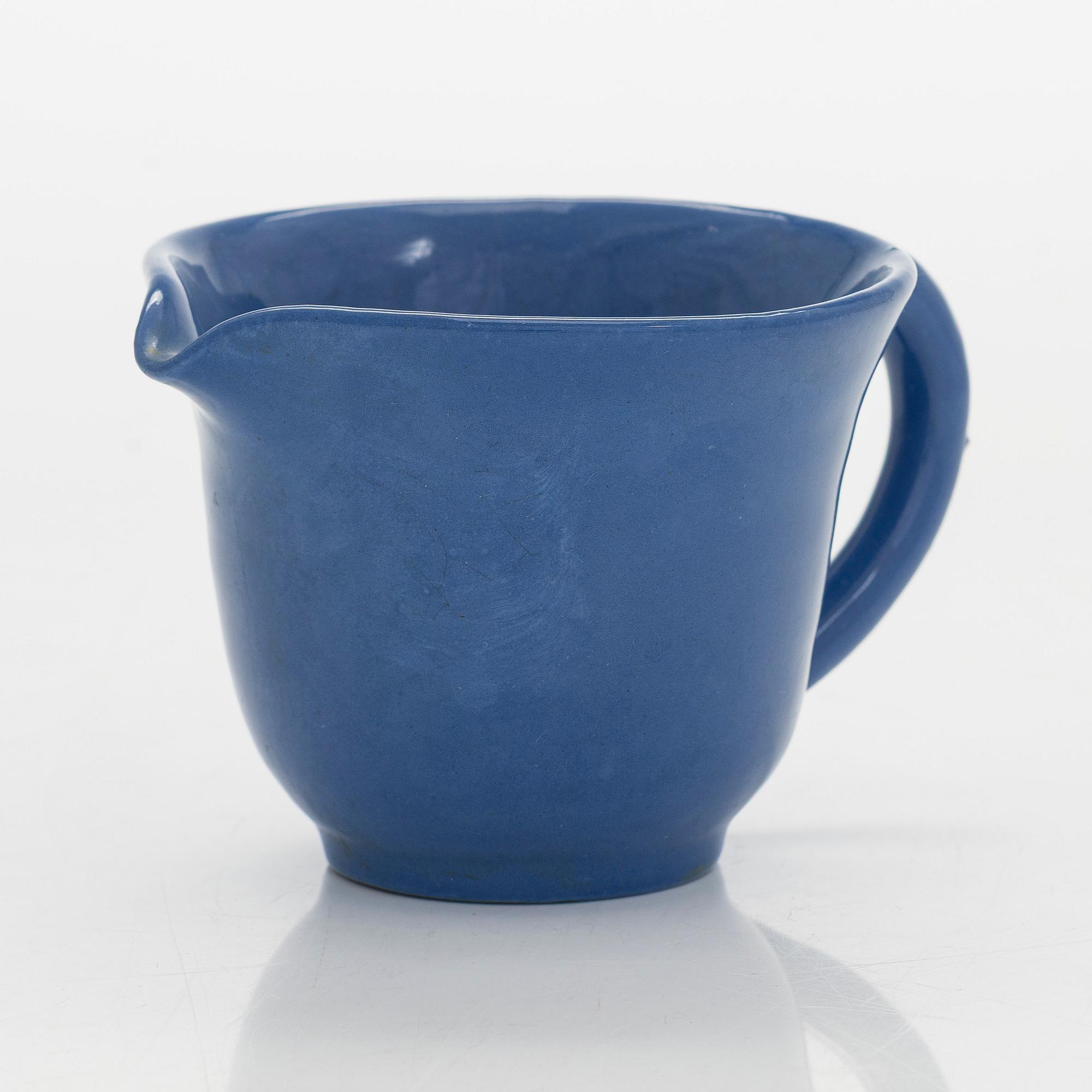 Marita Lybeck, a set of three ceramic plates and cream jug, red clay, signed ML.