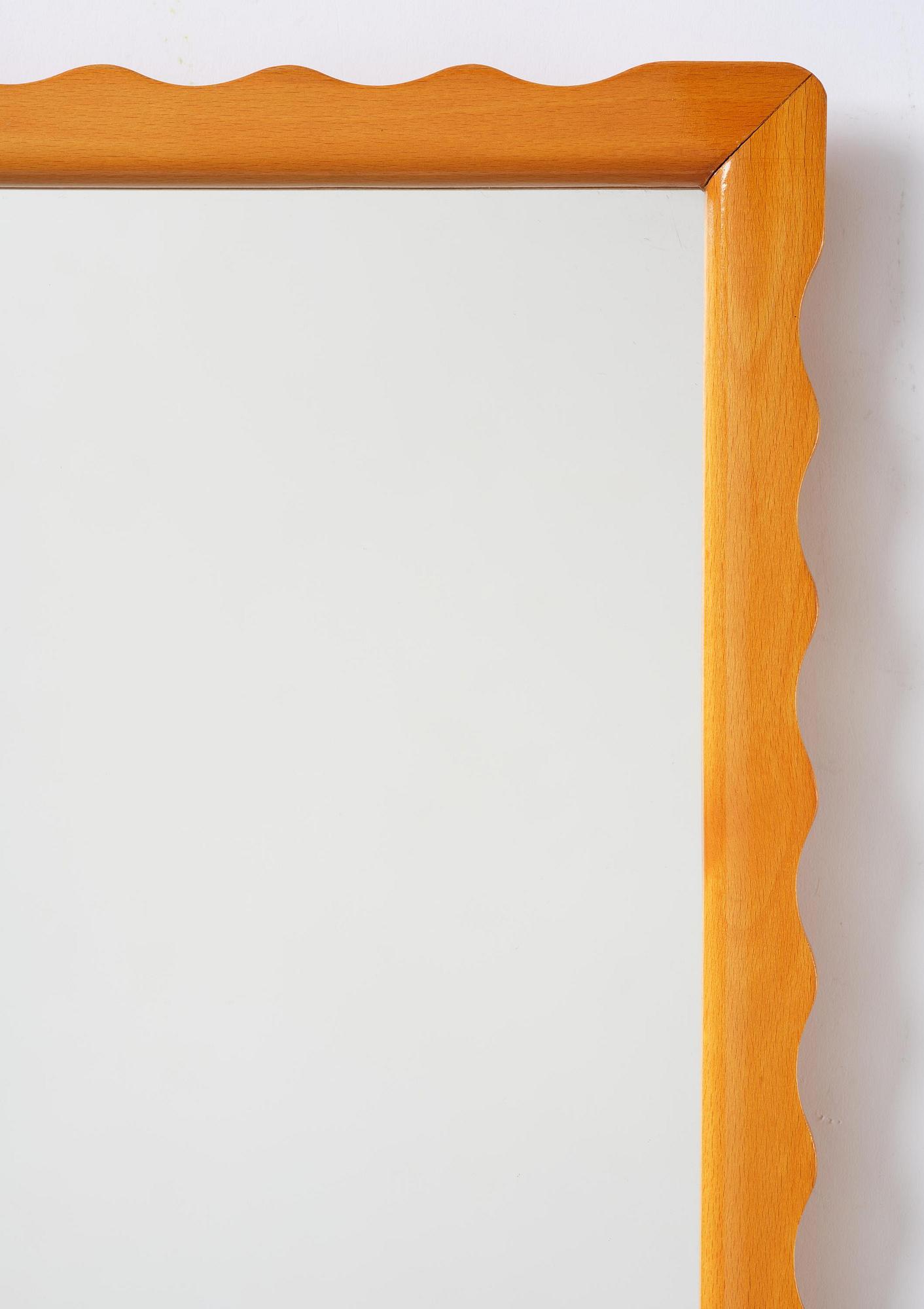 Swedish Modern, a wall mirror with wave-shaped frame, 1940s.