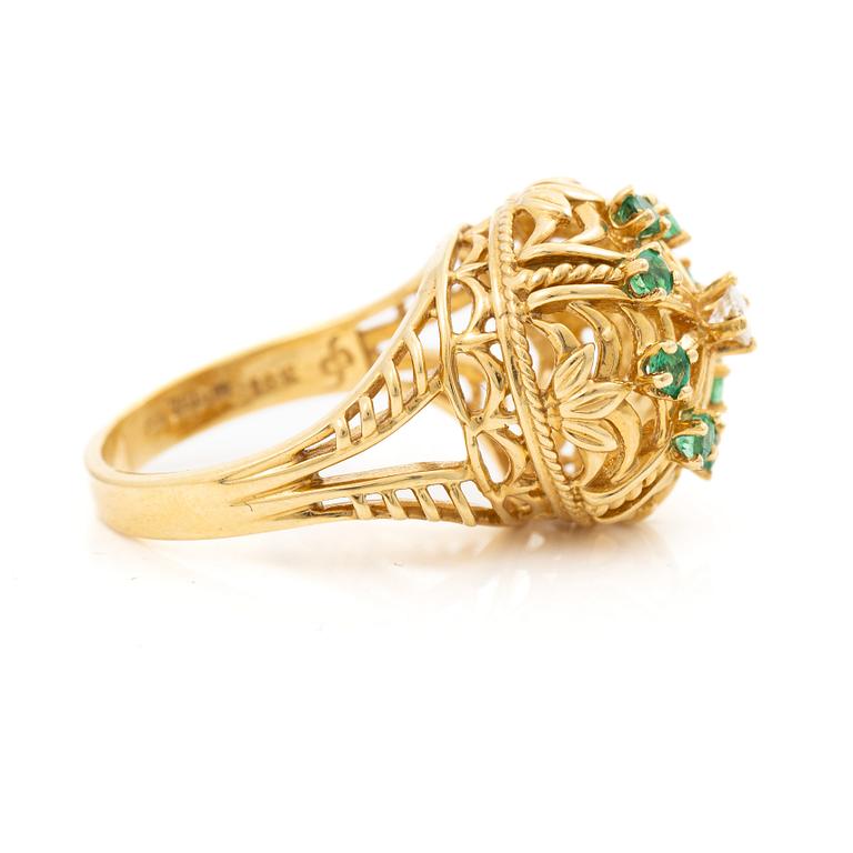 18K gold ring with small emeralds and a round brilliant-cut diamond.