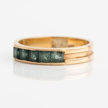 Ring with square-cut green stones.