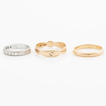 Rings, three pieces, gold, of which one set with brilliant-cut diamonds.