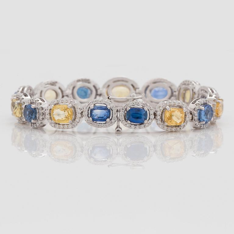 A yellow and blue sapphire and brilliant cut diamond bracelet. Total carat weight of sapphires circa 28.00 cts.