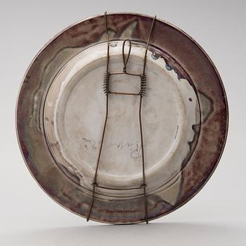 A mid-20th century glazed ceramic dish, signed TM.