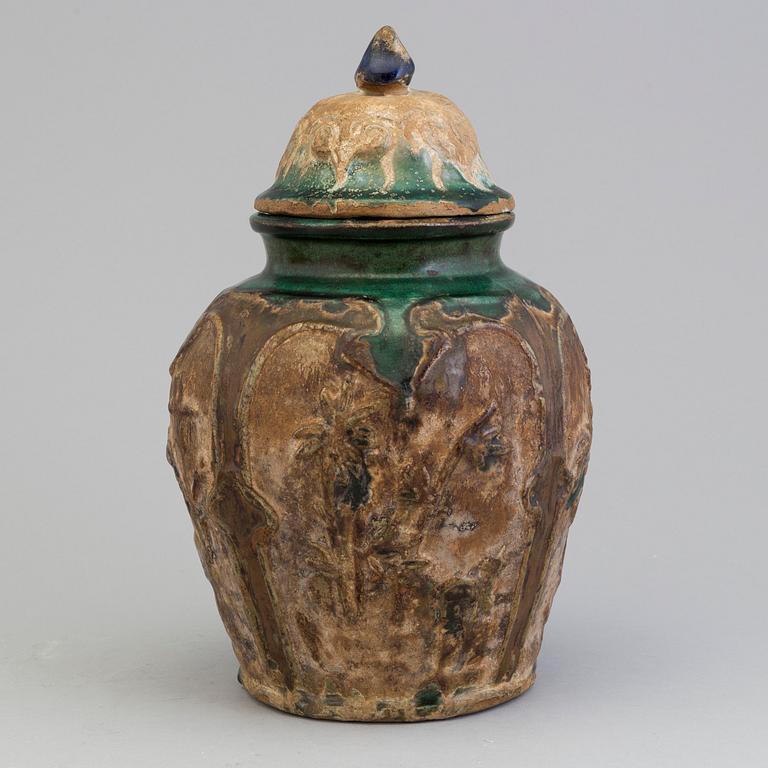 A Chinese 'Shiwan' ware pottery jar with cover, Qing dynasty, 19th century.