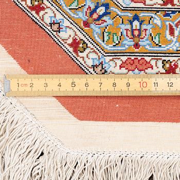 An Oktagonal  silk Qum rug, Central Persia, signed, c. 250 x 250 cm.