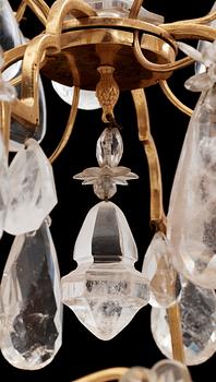 A late Baroque-style circa 1900 rock crystal twelve-light chandelier.