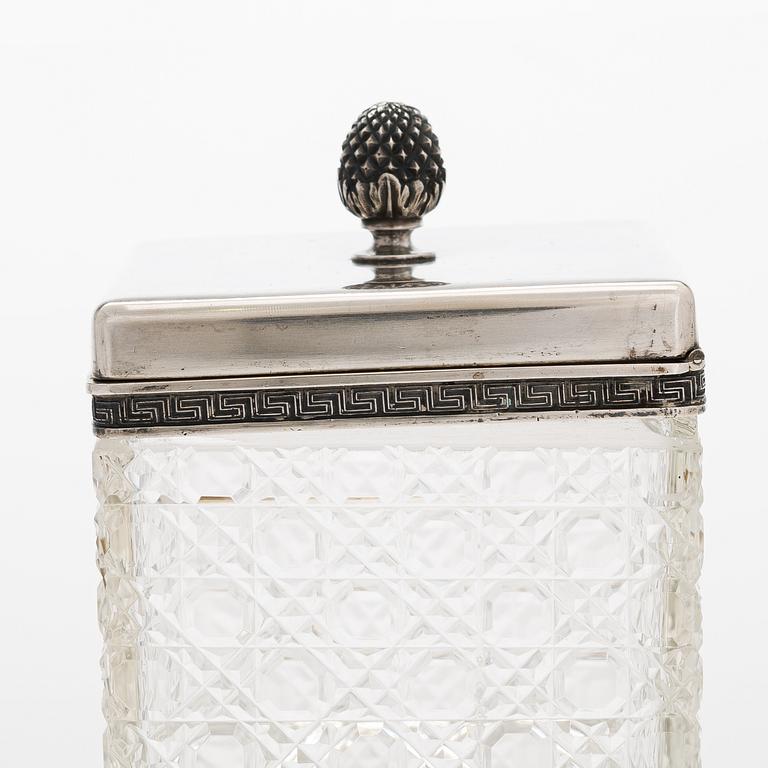 K. Fabergé, a pair of cut-glass toilette boxes in silver stand, Imperial Warrant mark, Moscow 1896.