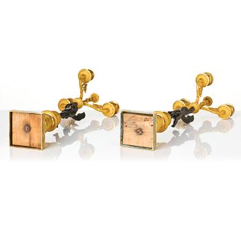 A pair of Empire three light ormolu and patinated bronze candelabra.