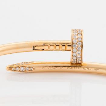 A Cartier "Juste un Clou" bracelet in 18K gold set with round brilliant-cut diamonds.