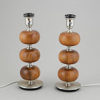 A pair of AB Stilarmatur walnut and metal table lamps, Sweden. Second half of the 20th century.