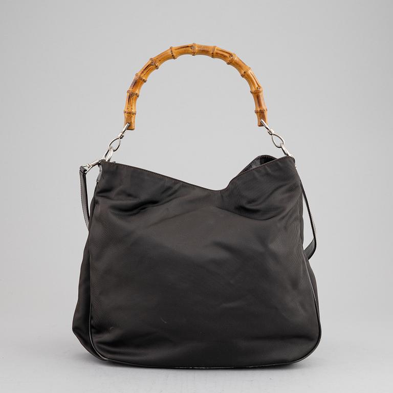 Gucci, a chocolate brown nylon handbag.