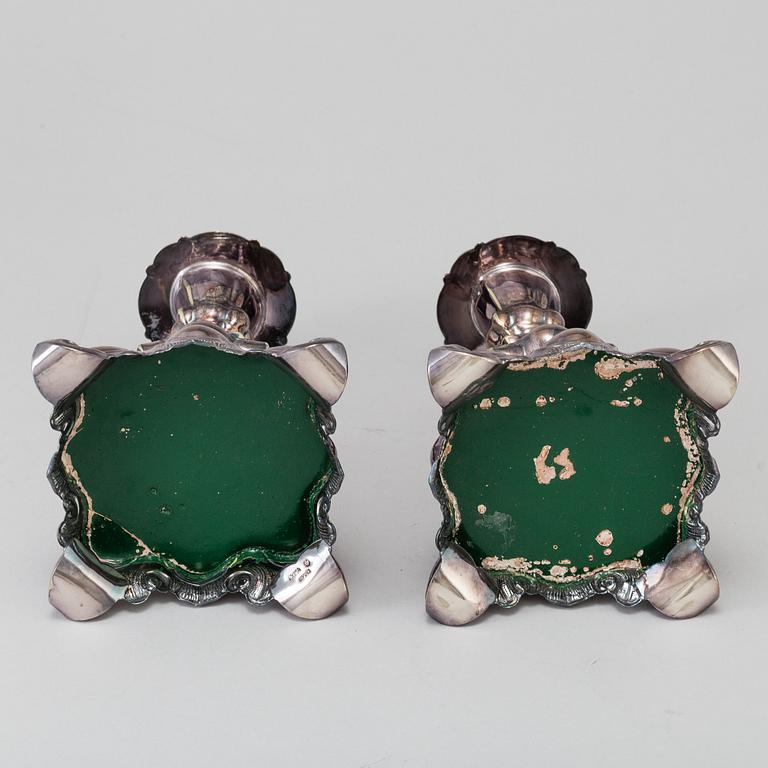 A pair of silver plate Rococo style candle sticks, 20th century.