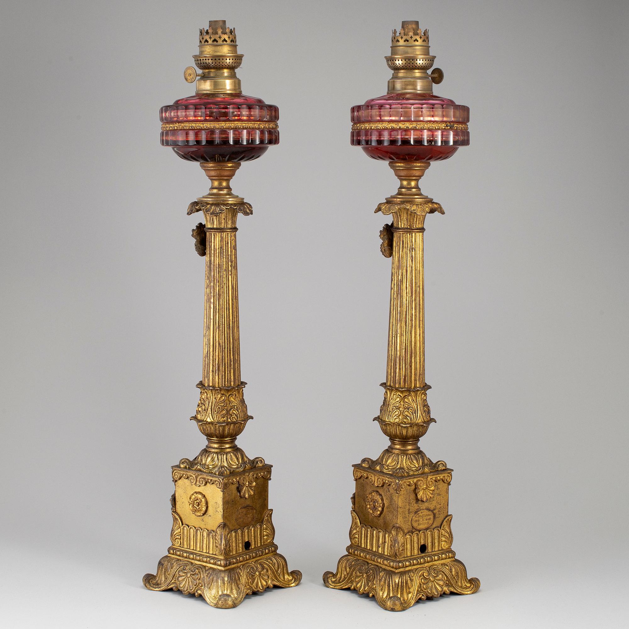 A pair of empire style table oil lamps, bronzed metal and glass, Dublot Freres, Rennes, late 19th century.