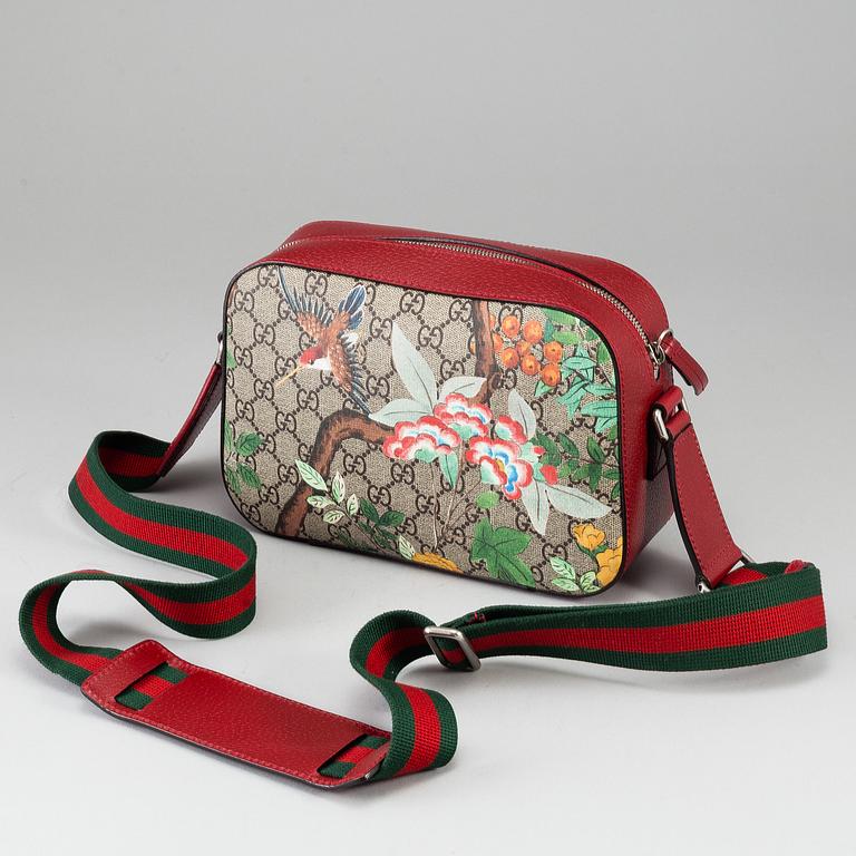 GUCCI, a patterned monogram canvas and leather bag.