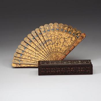 A black lacquer and gold fan in a silk clad box, Qing dynasty, 19th Century.