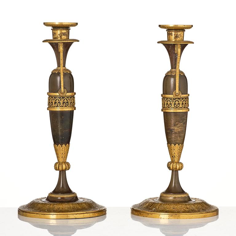 A pair of French Empire ormolu and patinated candlesticks in the manner of Claude Galle, Paris, early 19th century.