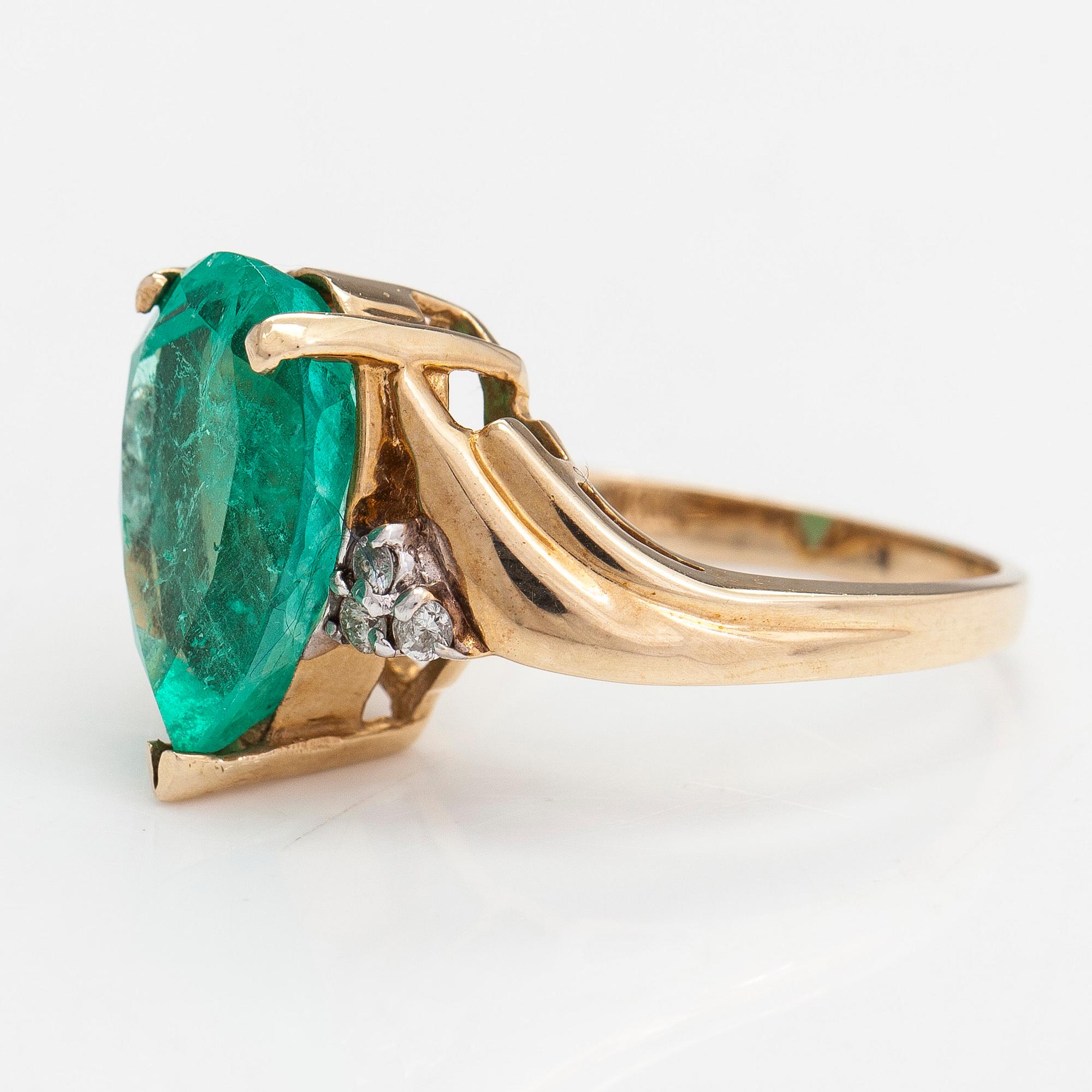 Ring, ca 10-11K gold with a pear shaped emerald and diamonds approx 0.10 ct in total.
