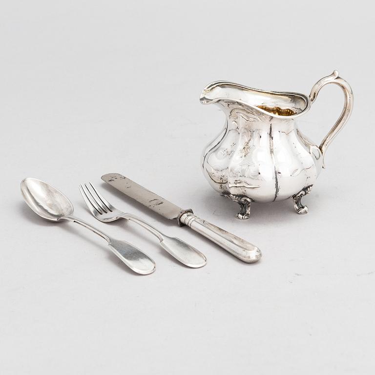 A Russian silver milk jug, and a silver fork, knife and spoon, Saint Petersburg 19th century.