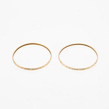 A pair of 18K gold bracelets for children.