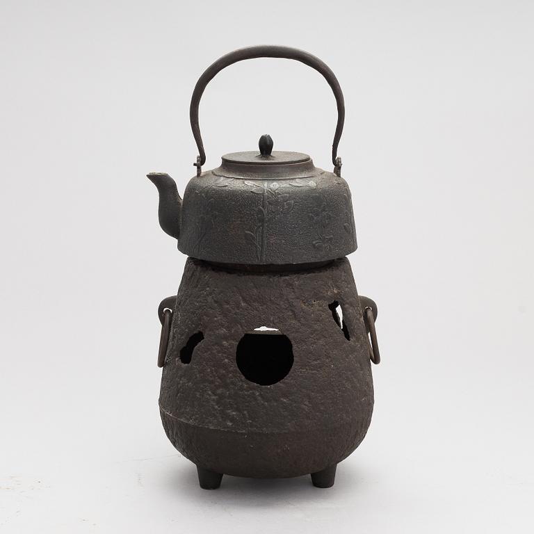 Two teapots and a hibachi brazier, Japan, early/ first half of the 20th century.