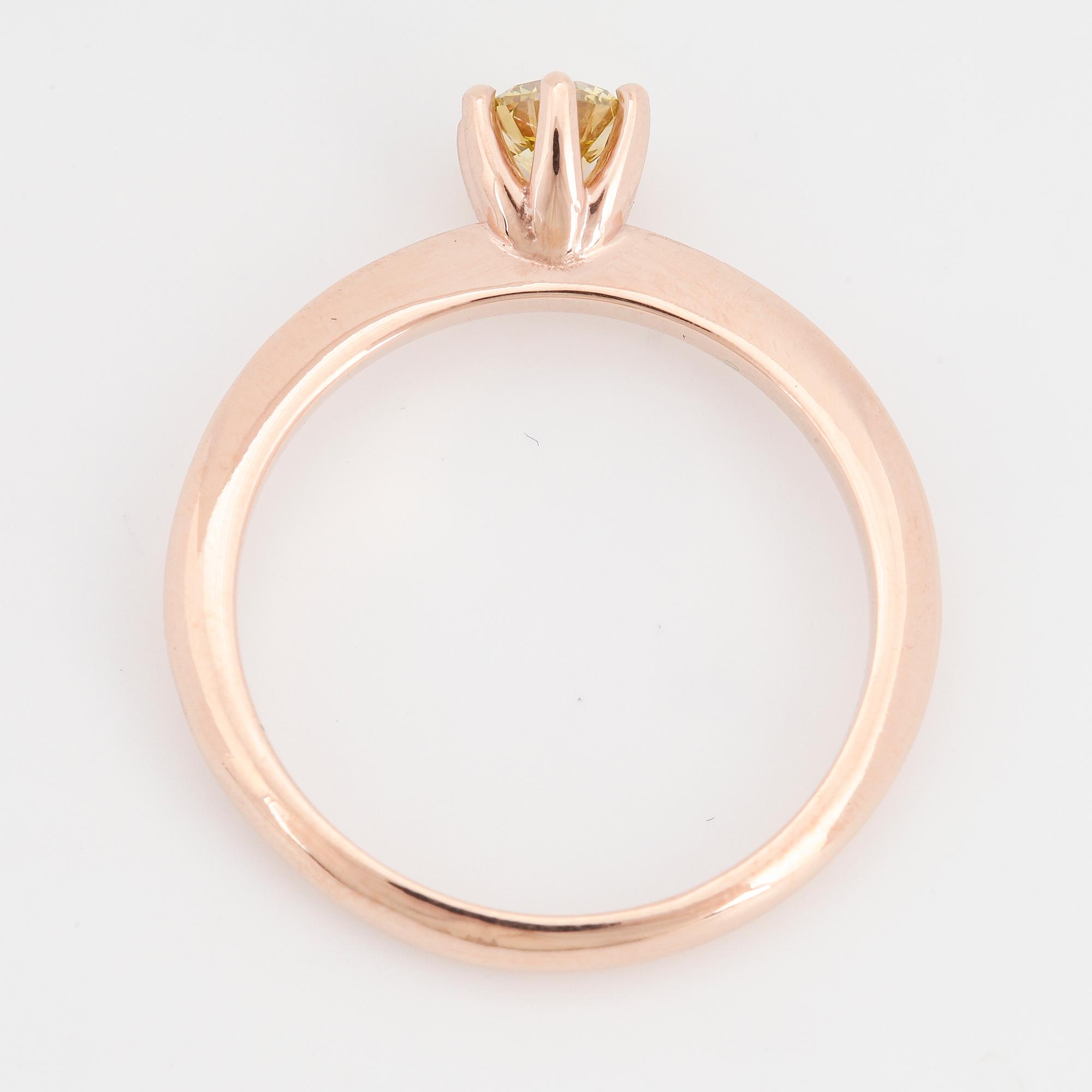 Colour treated yellow brilliant-cut diamond.