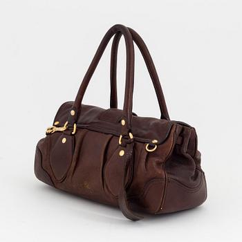 Prada, a brown leather bag.