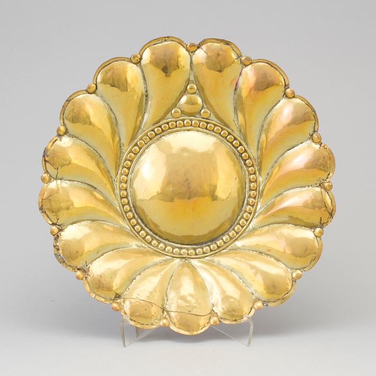 A 17th century brass wall plaque.