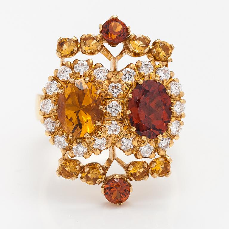 An 18K gold ring "Sophia Albertina", garnets, citrines, diamonds ca. 0.54 ct in total. Ofelia Jewelry, Helsinki 1998.