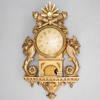 A Gustavian style wall clock, circa 1900.