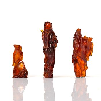A group of three amber scultpures, late Qing dynasty/early 20th Century.