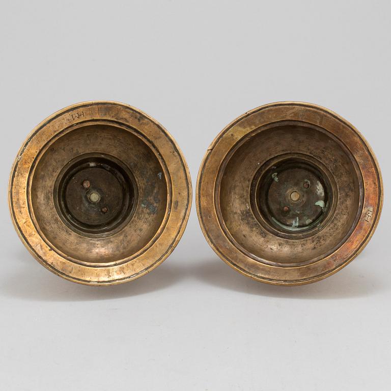A pair of 17th century brass candlesticks.
