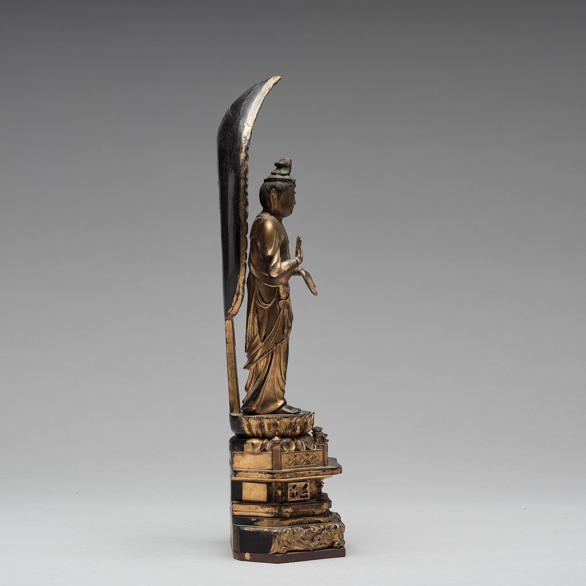 A Japanese gilt and lacquered wooden figure of Buddha and a travel shrine, Edo Period, 19th century.