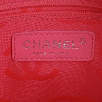 CHANEL, a black leather quilted pochette with short shoulder strap.