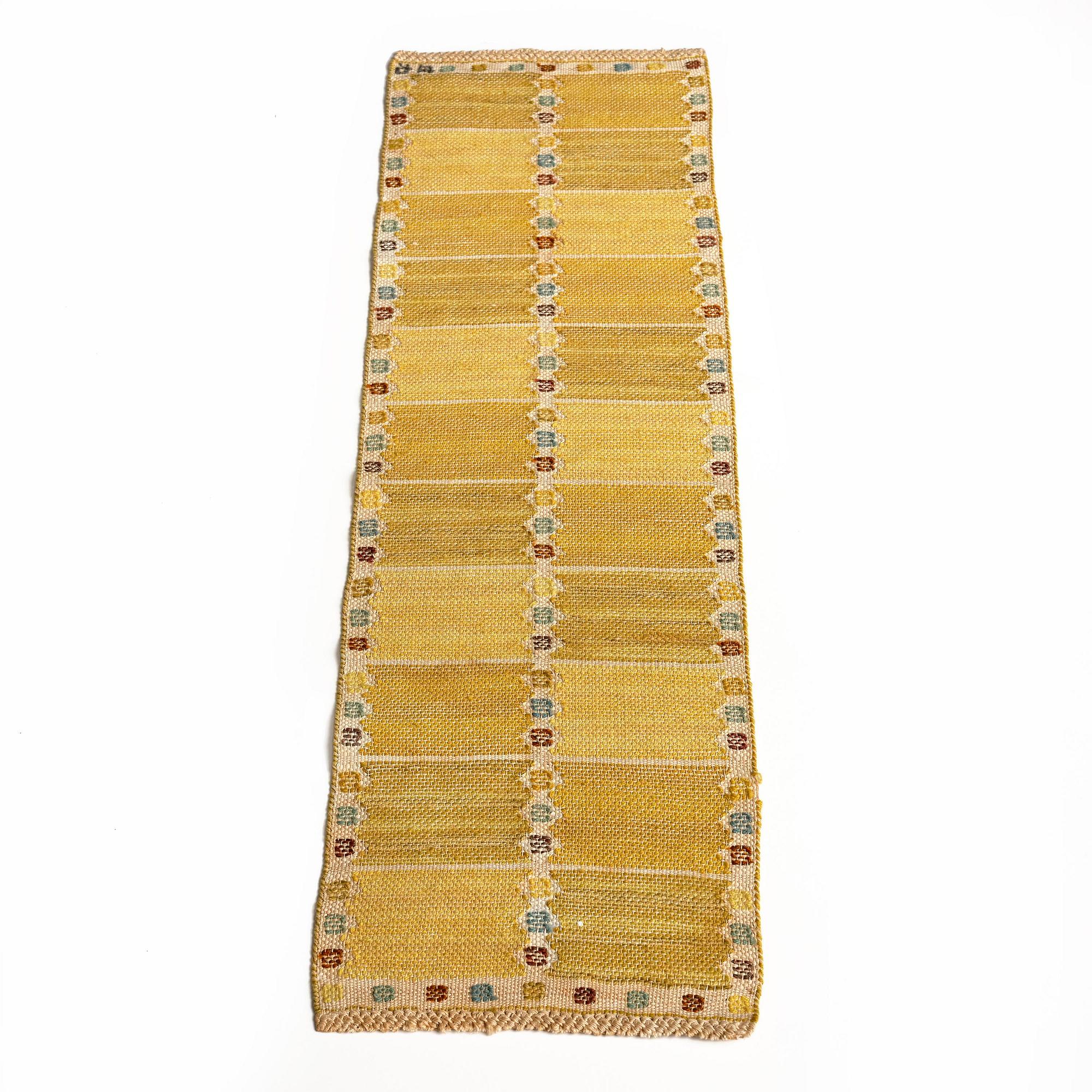 Barbro Nilsson, a 'Kvadrater på linne, gul' textile, flat weave, c 84 x 26 cm, signed BN.
