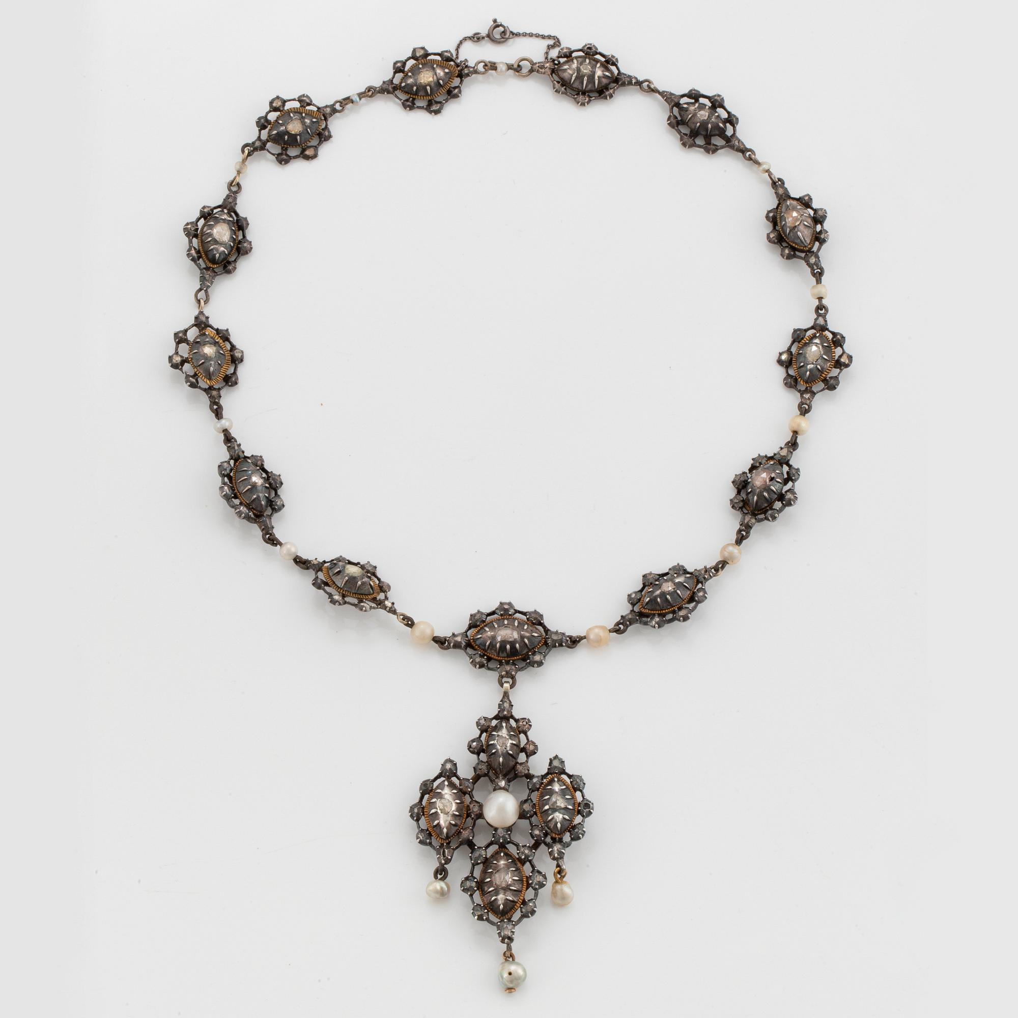 A silver necklace/pendant set with rose-cut diamonds and pearls.