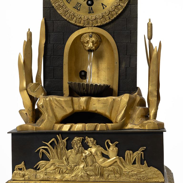 A French Charles X ormolu and patinated bronze mantel clock, ca 1820's.