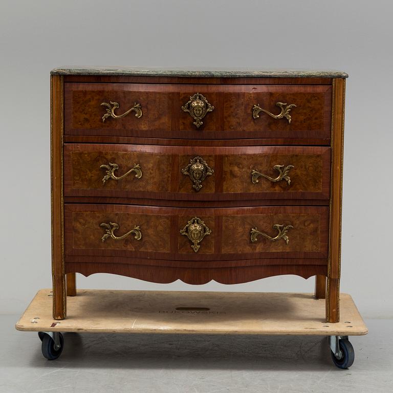 A 20th century rococo style chest of three drawers.