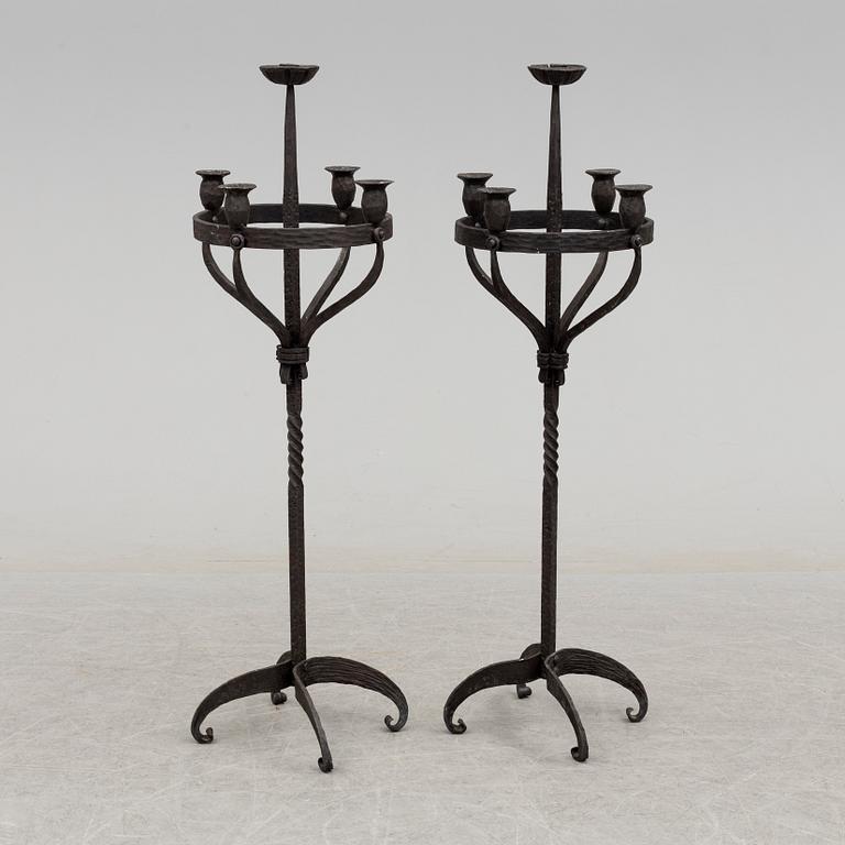 a pair of iron floor candle sticks, 20th century.