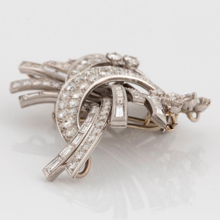 A platinum and 18K gold brooch set with round brilliant- and baguette-cut diamonds.